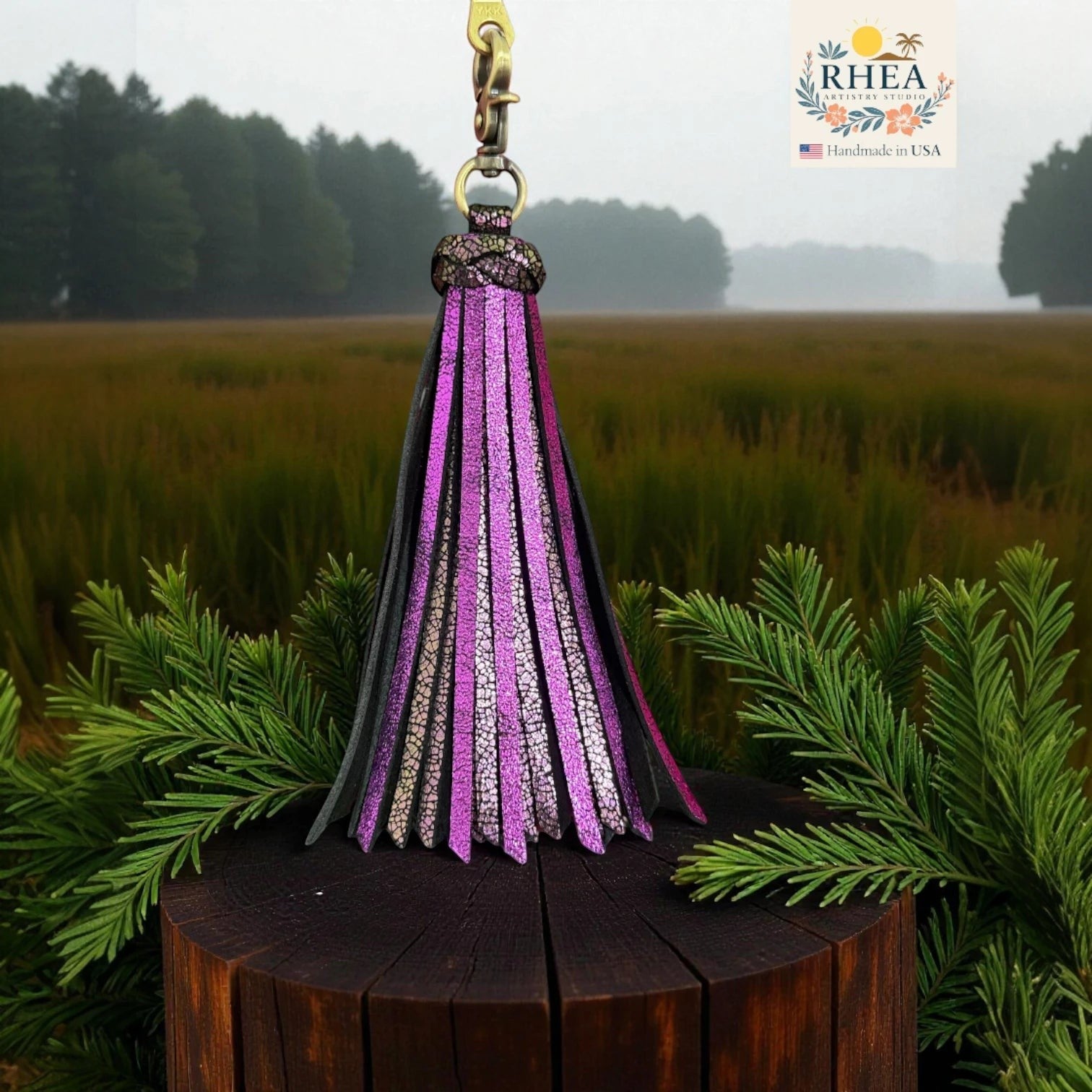 Rhea Artistry Studio large handmade leather tassel keychain in purple and silver glitter with a lobster clasp, perfect for bags.