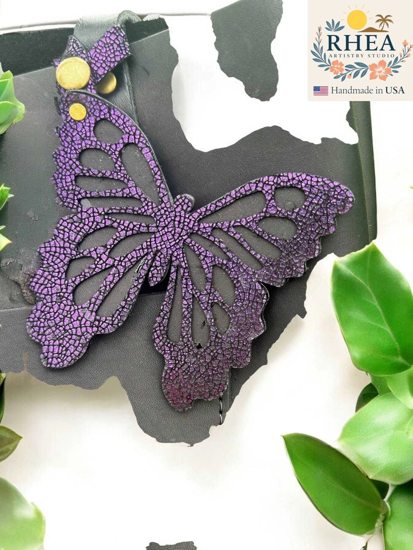 Rhea Artistry Studio purple iridescent leather butterfly charm with metallic finish and snap closure.