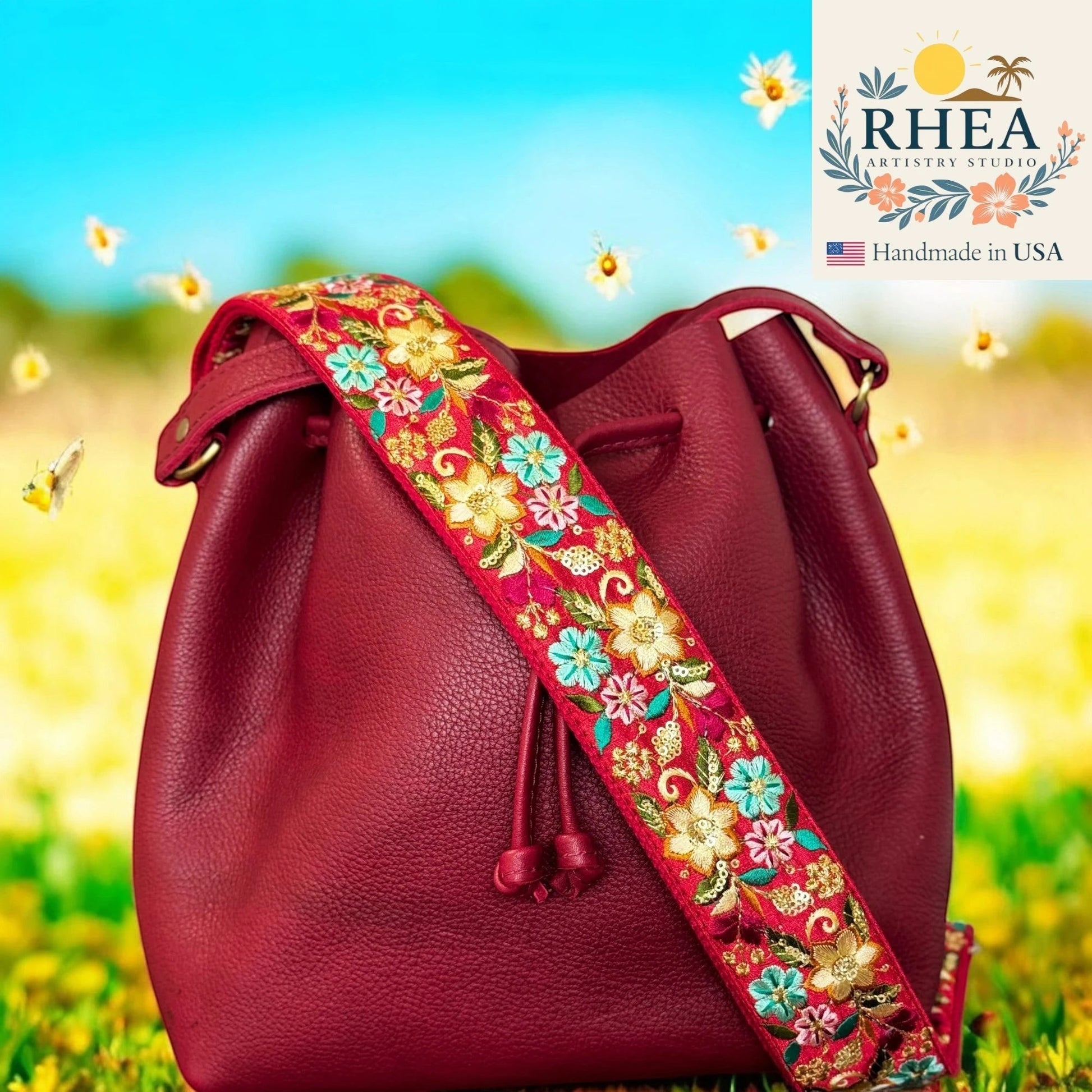 Rhea Artistry Studio red embroidered floral lace crossbody strap with adjustable length and brushed brass hardware.