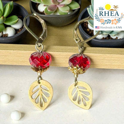 Rhea Artistry Studio handcrafted red faceted glass leaf drop earrings with brass charms and leverback closures, approx. 2 inches long.