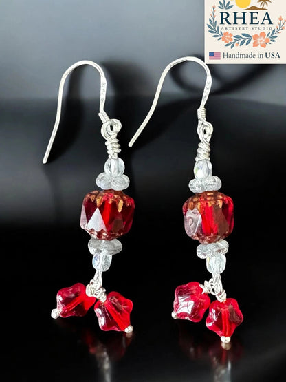 Rhea Artistry Studio crimson red glass bead drop earrings with star charms and silver-plated French hooks.
