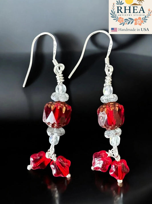 Rhea Artistry Studio crimson red glass bead drop earrings with star charms and silver-plated French hooks.