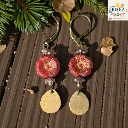 Rhea Artistry Studio handmade red hibiscus glass bead drop earrings with brass hardware and leverback hooks.
