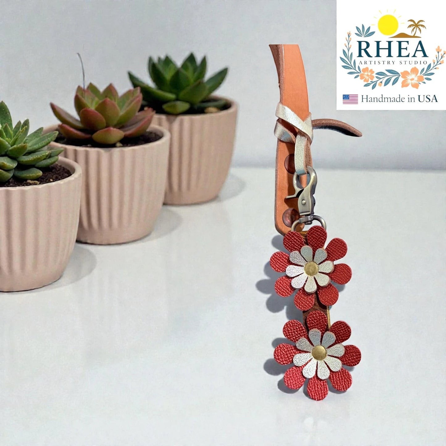 Rhea Artistry Studio handmade double-layer red and white leather daisy purse charm with gold center.