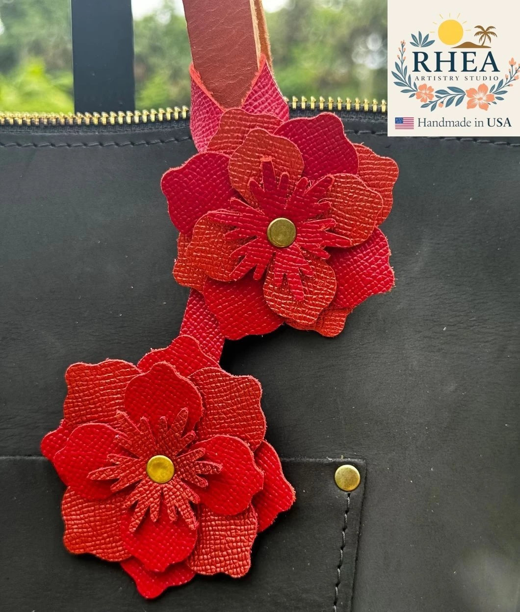 Rhea Artistry Studio double leather flower charm in red and brick red, handcrafted from full-grain leather with brass rivets.