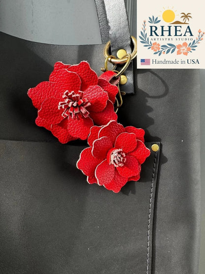 Rhea Artistry Studio red leather flower charm with detailed petals and stamen, featuring a lobster clasp and split ring.