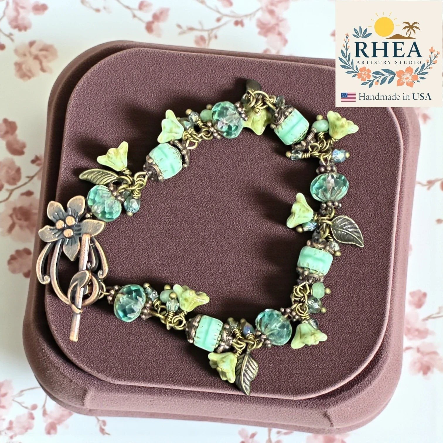 Rhea Artistry Studio sea glass bloom glass bead bracelet with silver-toned accents and floral clasp. Handmade in USA.