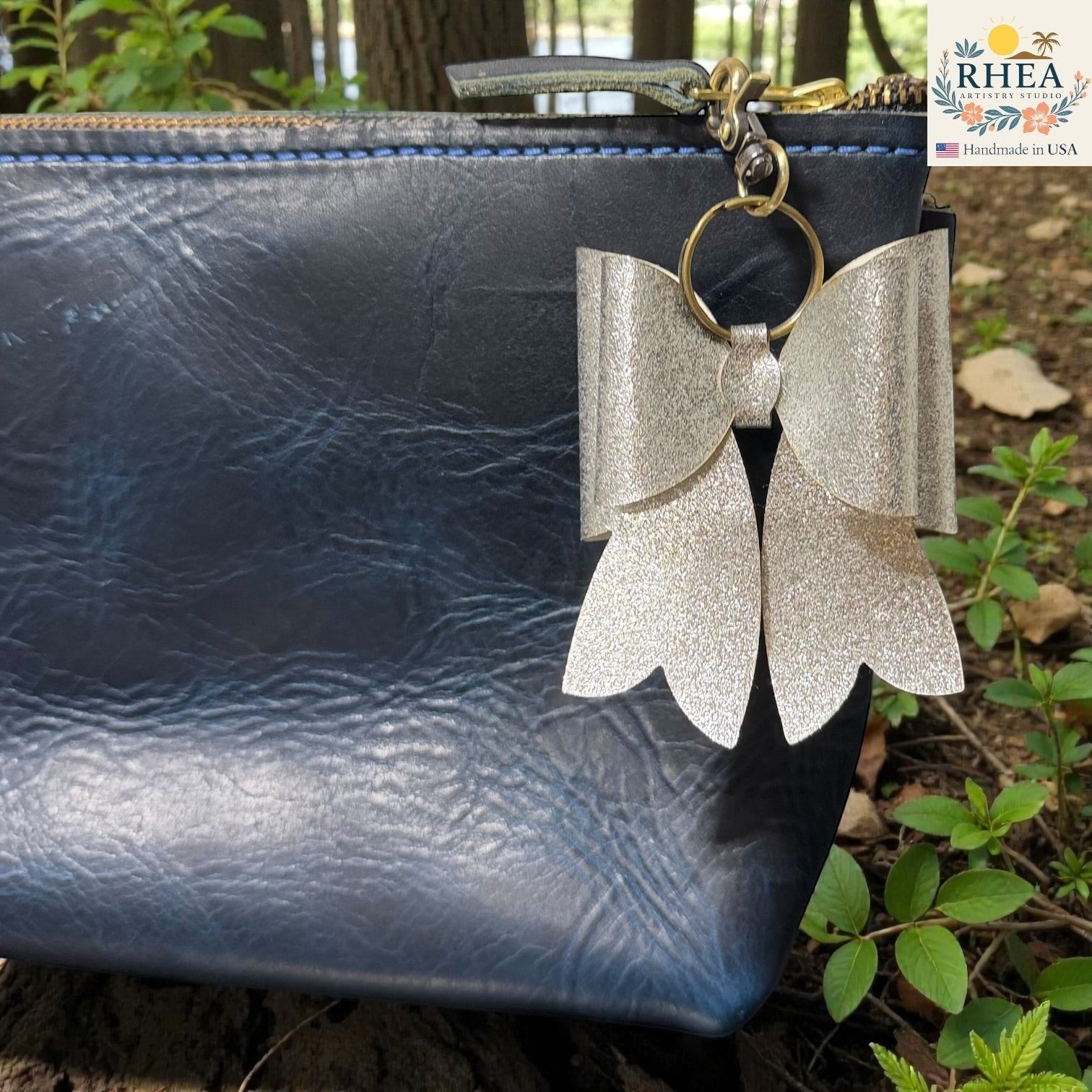 Rhea Artistry Studio handmade silver glitter double layer French bow bag charm with brass hardware.