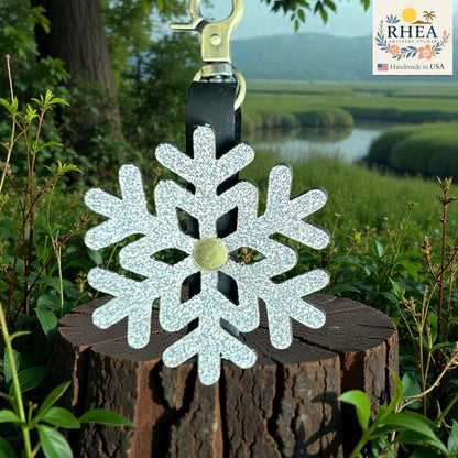 Rhea Artistry Studio silver glitter snowflake leather bag charm with brass accent and clasp.