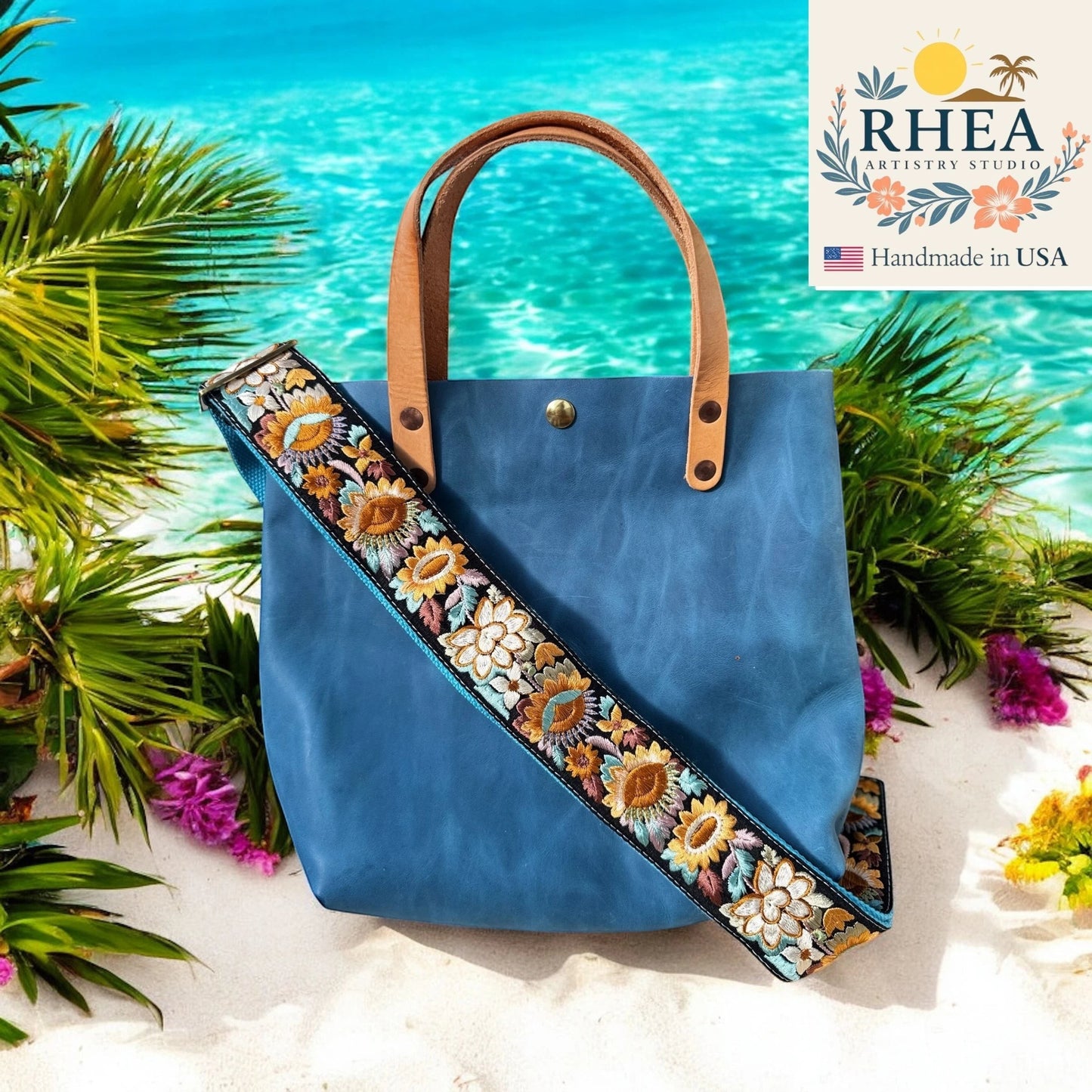 Rhea Artistry Studio blue tote bag with a 2-inch wide sunflower embroidered crossbody strap, adjustable and handmade.