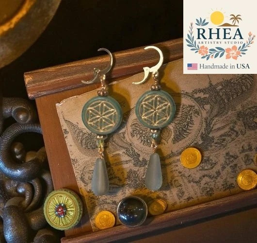 Rhea Artistry Studio teal coin of life earrings with pale blue glass drops and 24k gold plated brass findings.