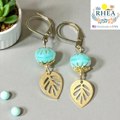Rhea Artistry Studio teal faceted glass bead and brass leaf drop earrings, approx. 2 inches long, with leverback closures.