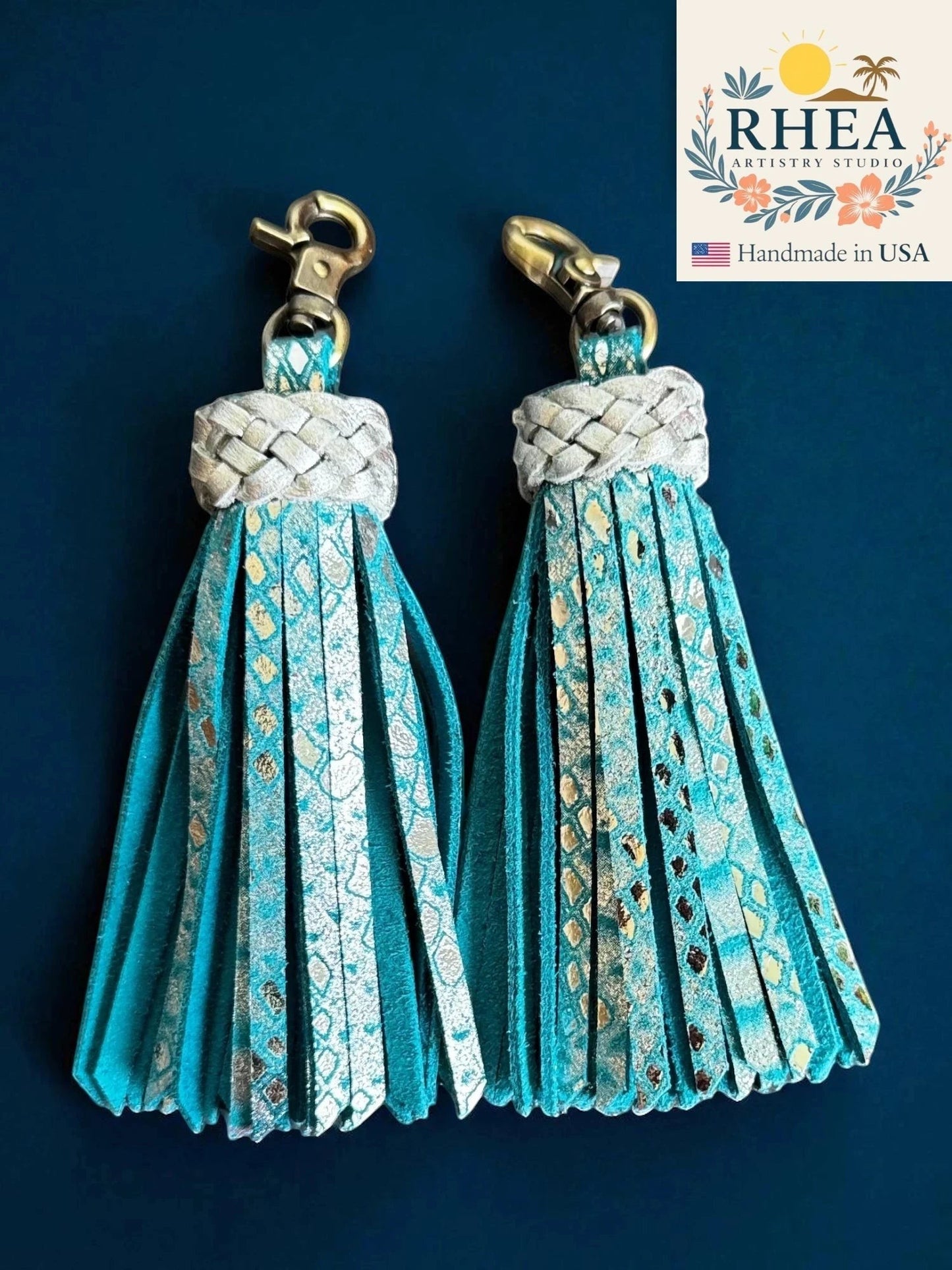 Rhea Artistry Studio handmade teal leather tassel keychain with metallic snake print accents and antique brass lobster clasp.