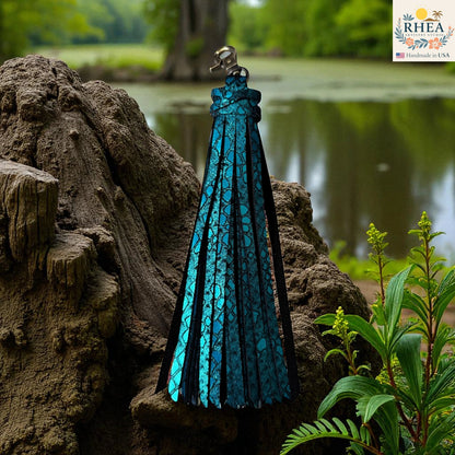 Rhea Artistry Studio handmade large teal leather tassel keychain with glitter finish and antique brass lobster clasp, 7.25" long.