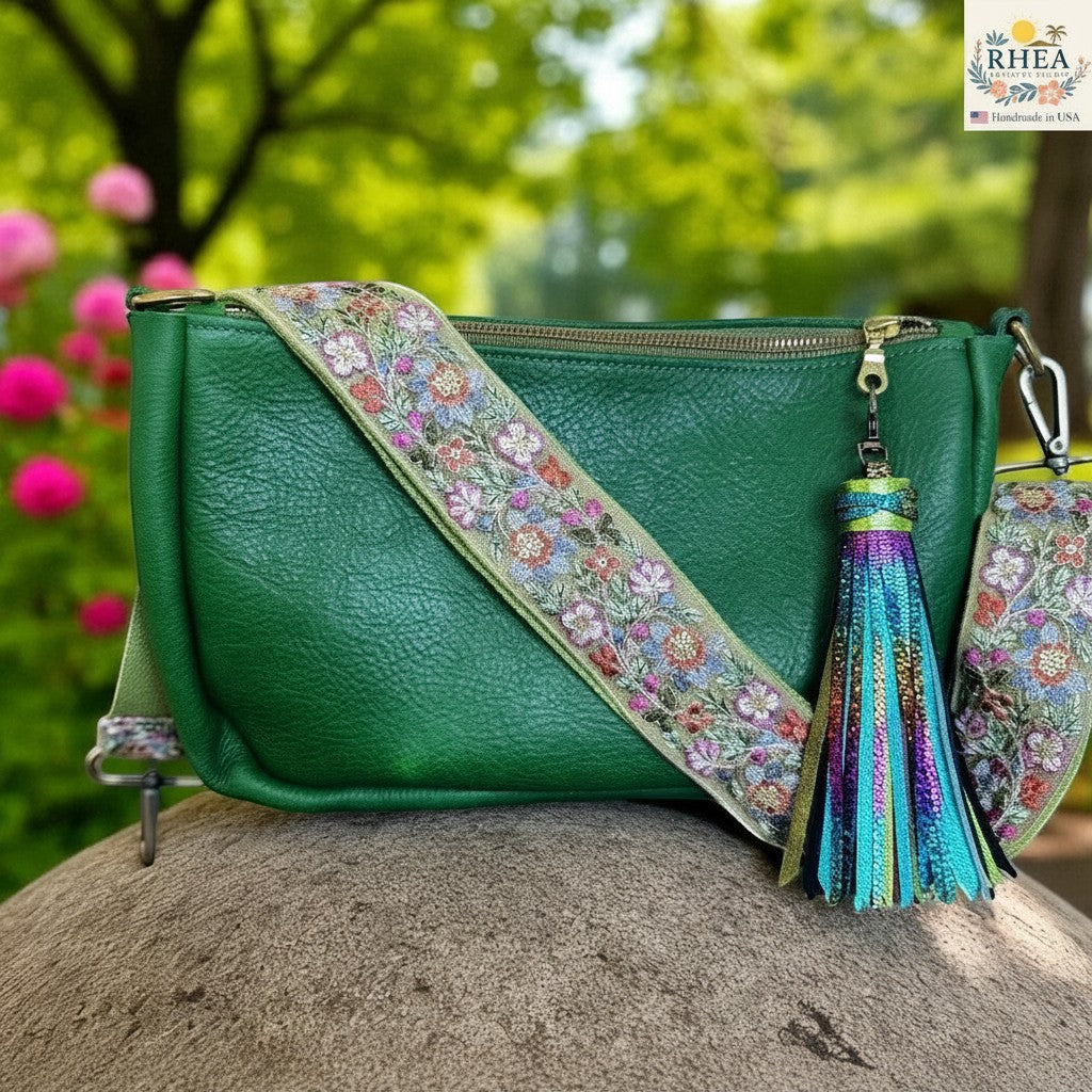 Rhea Artistry Studio green leather crossbody bag with a 2-inch adjustable Verdant Weave embroidered strap and a colorful tassel.