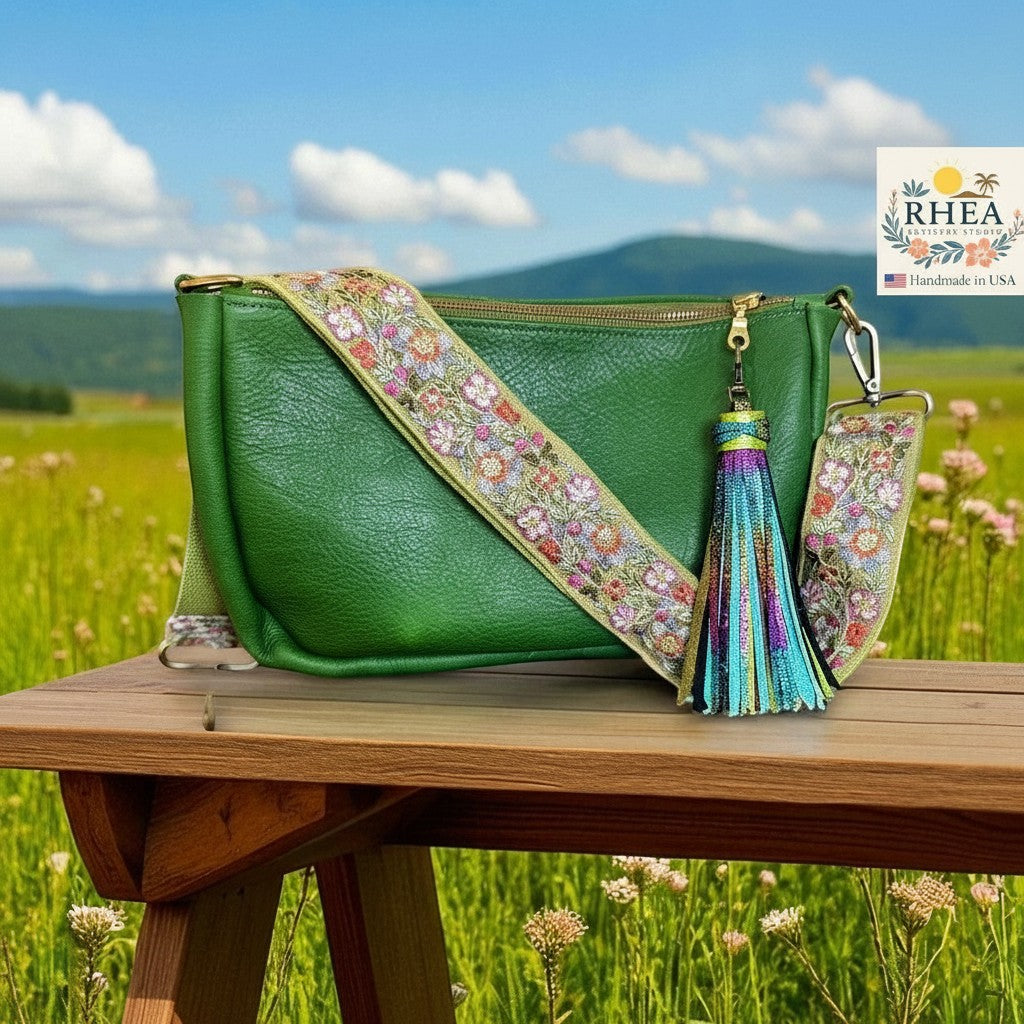 Rhea Artistry Studio green crossbody bag with a 2-inch wide Verdant Weave embroidered floral lace strap and a colorful tassel.