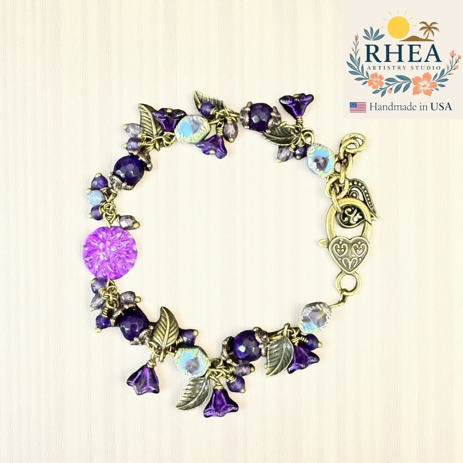 Rhea Artistry Studio violet glass bead bracelet with floral and leaf accents, antique brass clasp.