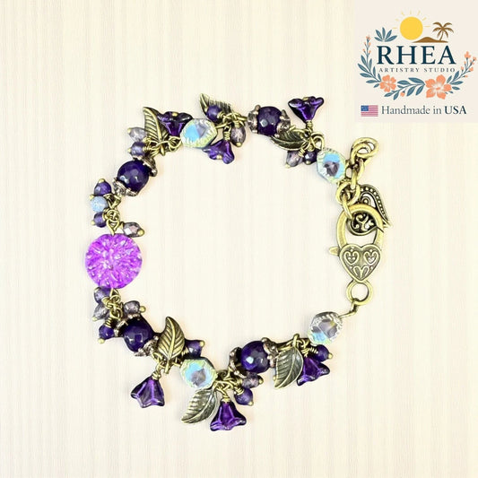 Rhea Artistry Studio violet glass bead bracelet with floral and leaf accents, antique brass clasp.