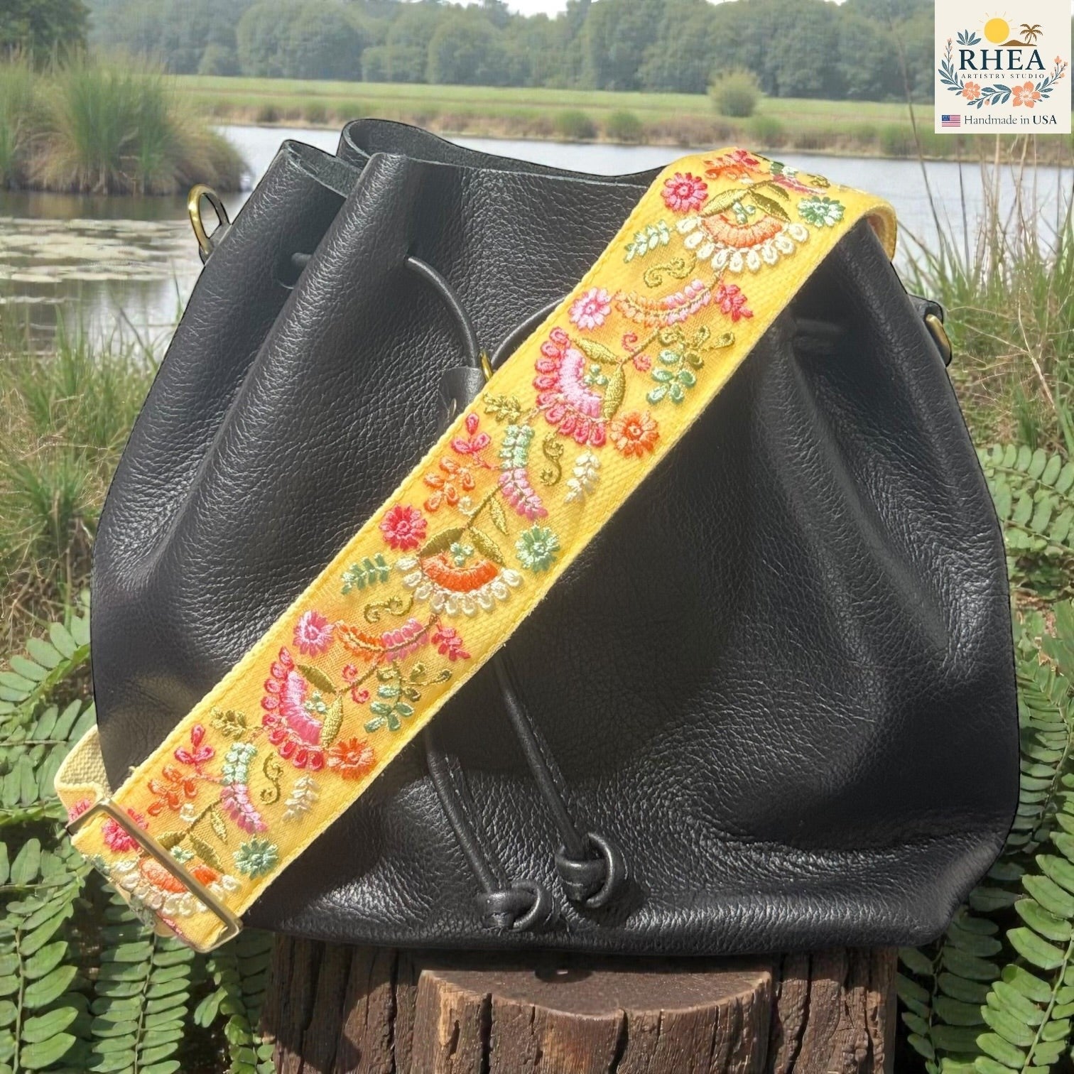 Rhea Artistry Studio yellow embroidered lace crossbody strap with floral pattern and brushed brass hardware.