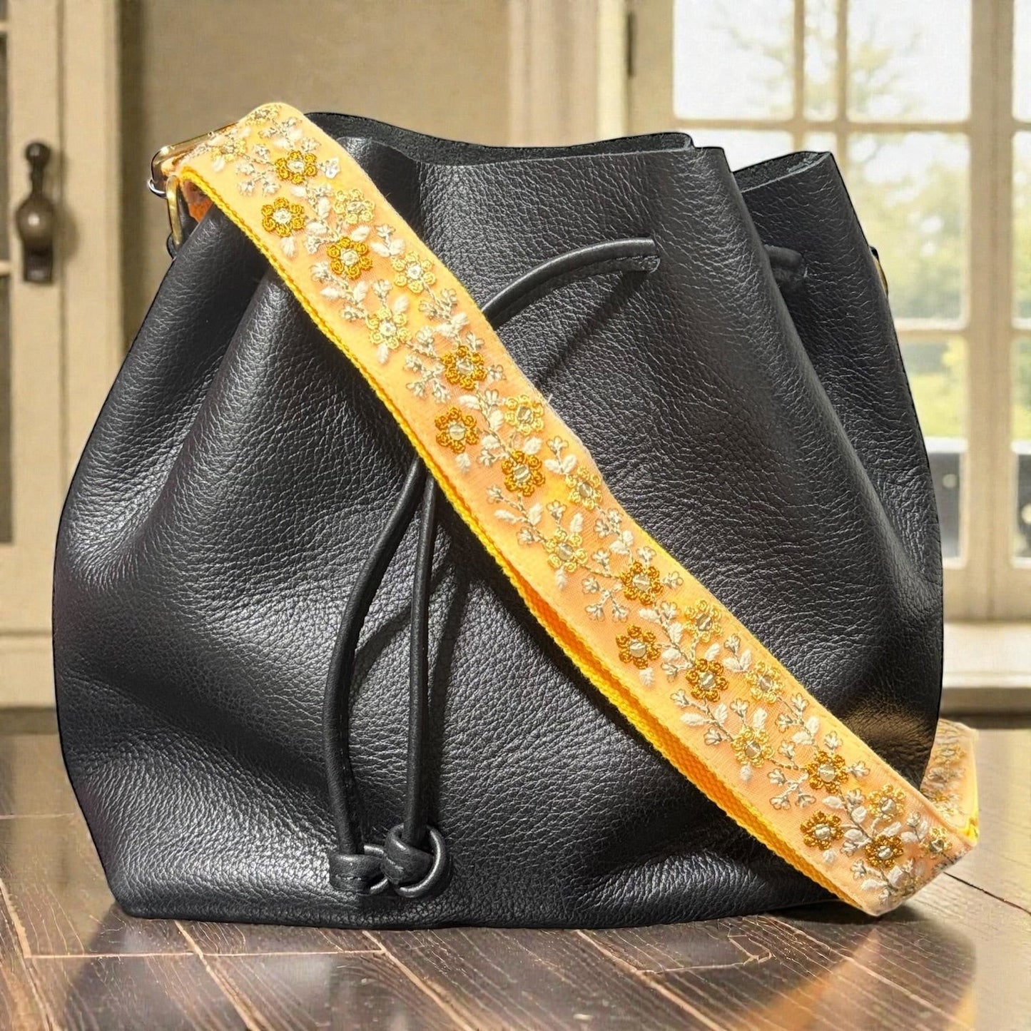 Rhea Artistry Studio yellow embroidered floral crossbody purse strap with brushed brass hardware.