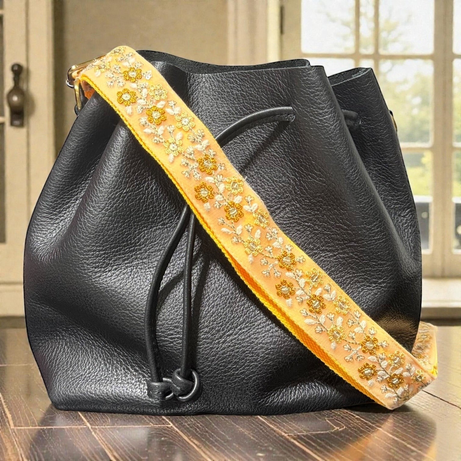 Rhea Artistry Studio yellow embroidered floral crossbody purse strap with brushed brass hardware.