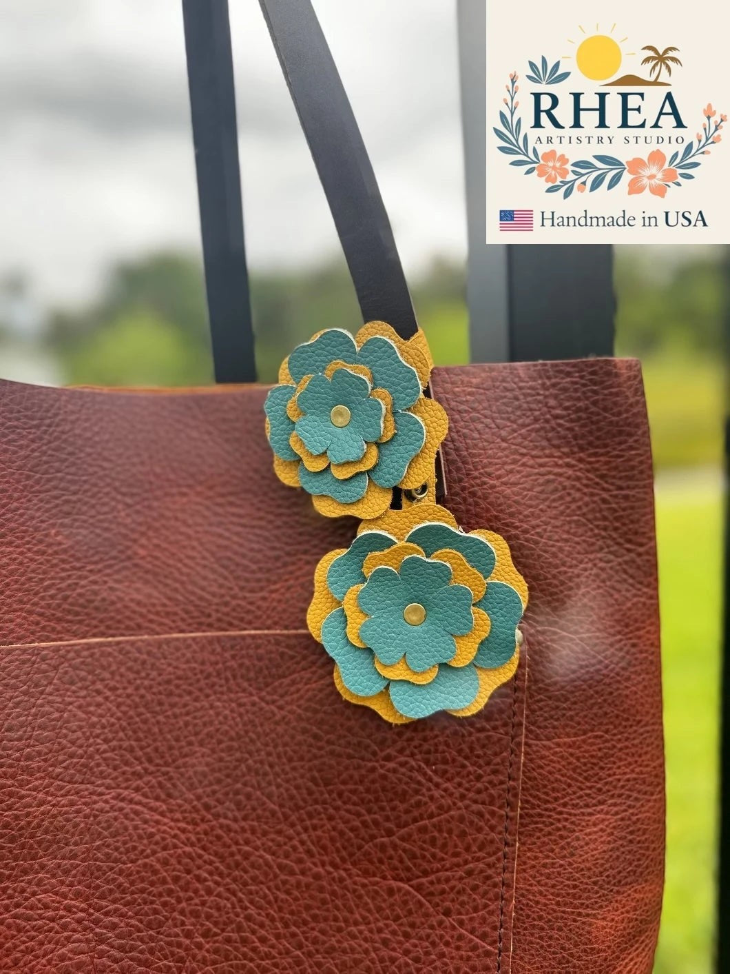Rhea Artistry Studio double leather flower charm in yellow and turquoise, featuring 3-inch and 3.5-inch layered petals with brass rivets.