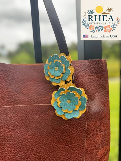 Rhea Artistry Studio double leather flower charm in yellow and turquoise, featuring 3-inch and 3.5-inch layered petals with brass rivets.