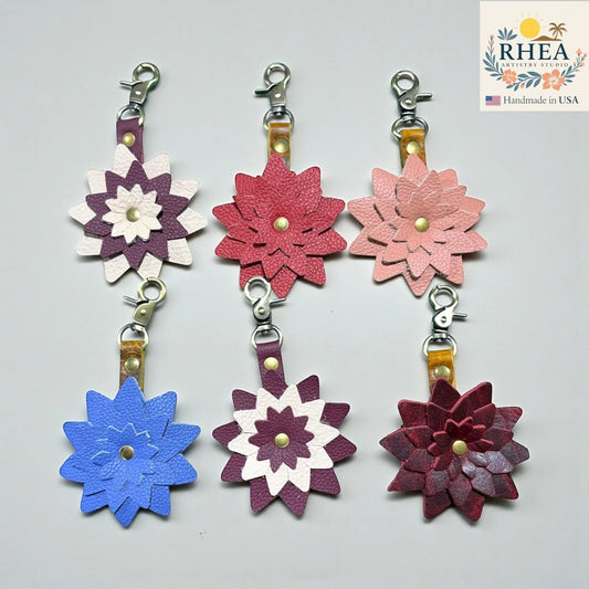 Set of colorful flower-shaped keychains on a gray background