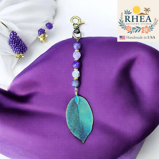 Handcrafted Whispers of Violet natural leaf bag charm featuring delicate violet tones, artisan-made for purses and keychains.